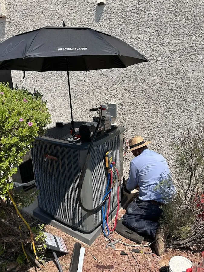 HVAC technician performing outdoor AC maintenance in Joplin